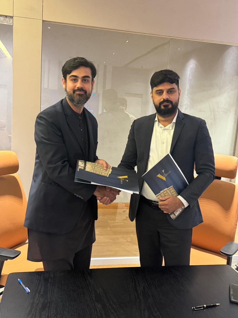 Alt Text: THEHMPD expert real estate consultants Tabish Mujahid collaborating with The Vertical team.