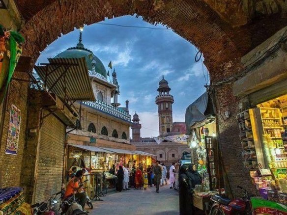 Panoramic view of the historic Walled City Lahore skyline featuring Mughal architecture and traditional heritage buildings.