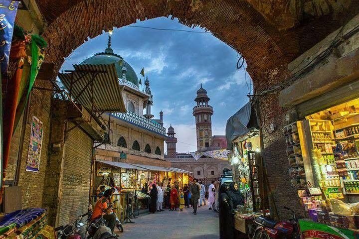 Panoramic view of the historic Walled City Lahore skyline featuring Mughal architecture and traditional heritage buildings.