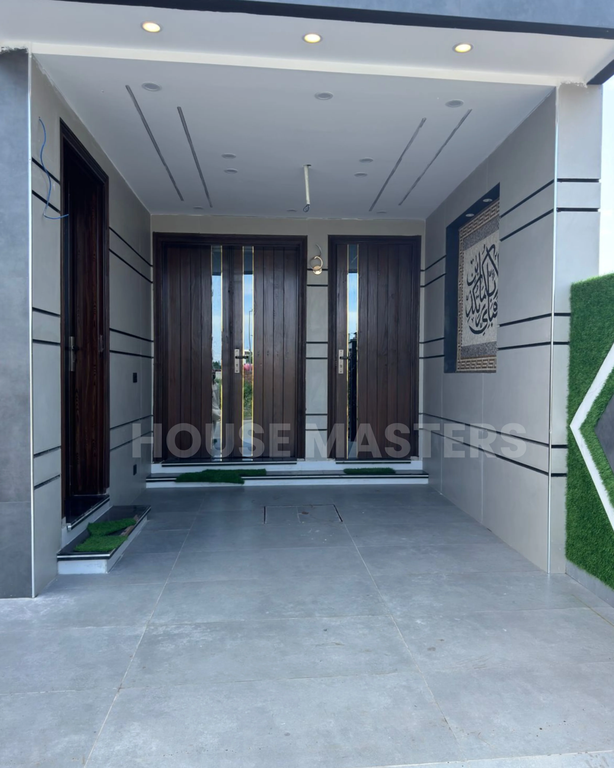 Contemporary room with ceiling fan and stylish wall design in a 5 Marla home