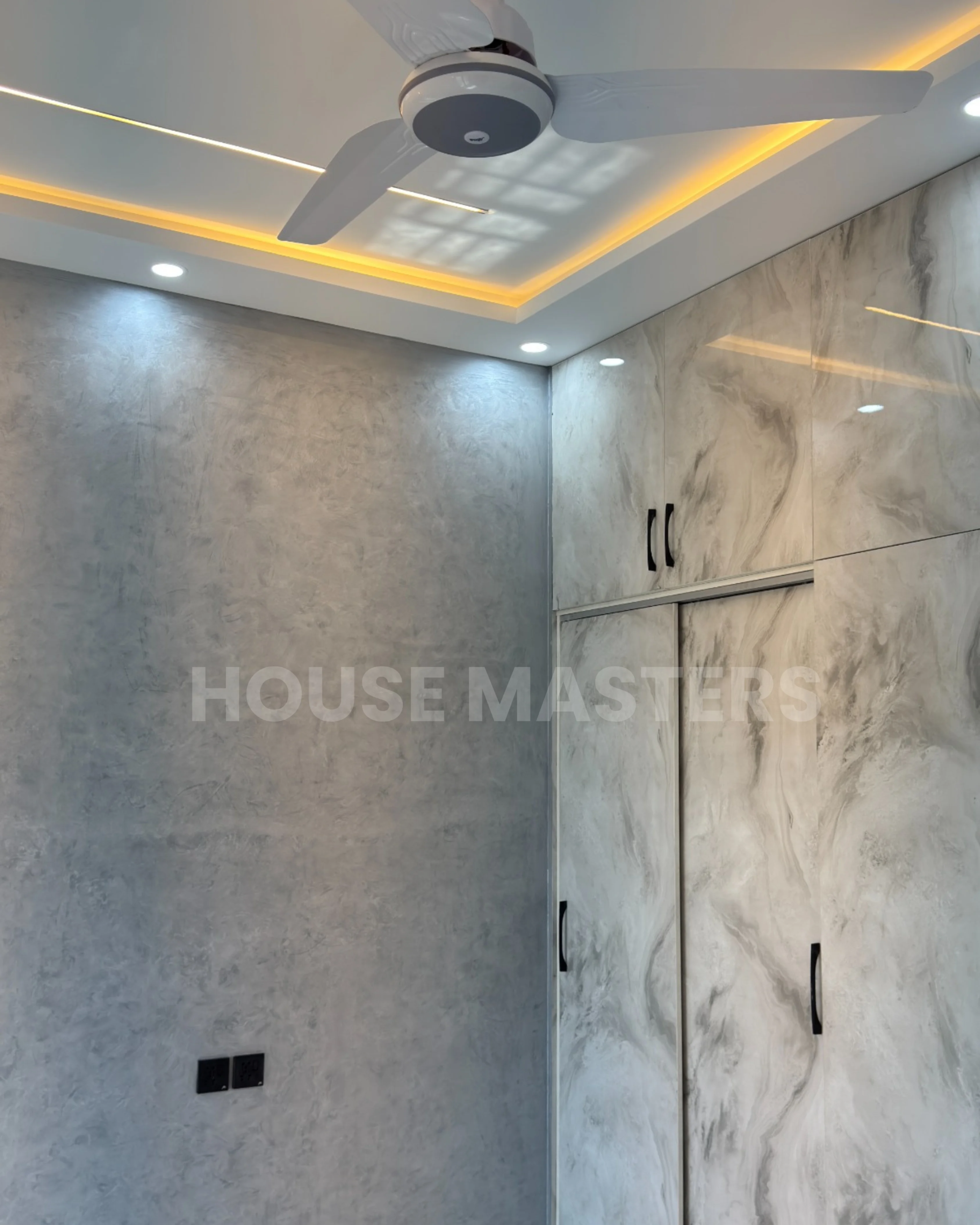 Bedroom with elegant marble design and ambient lighting in a 5 Marla residence