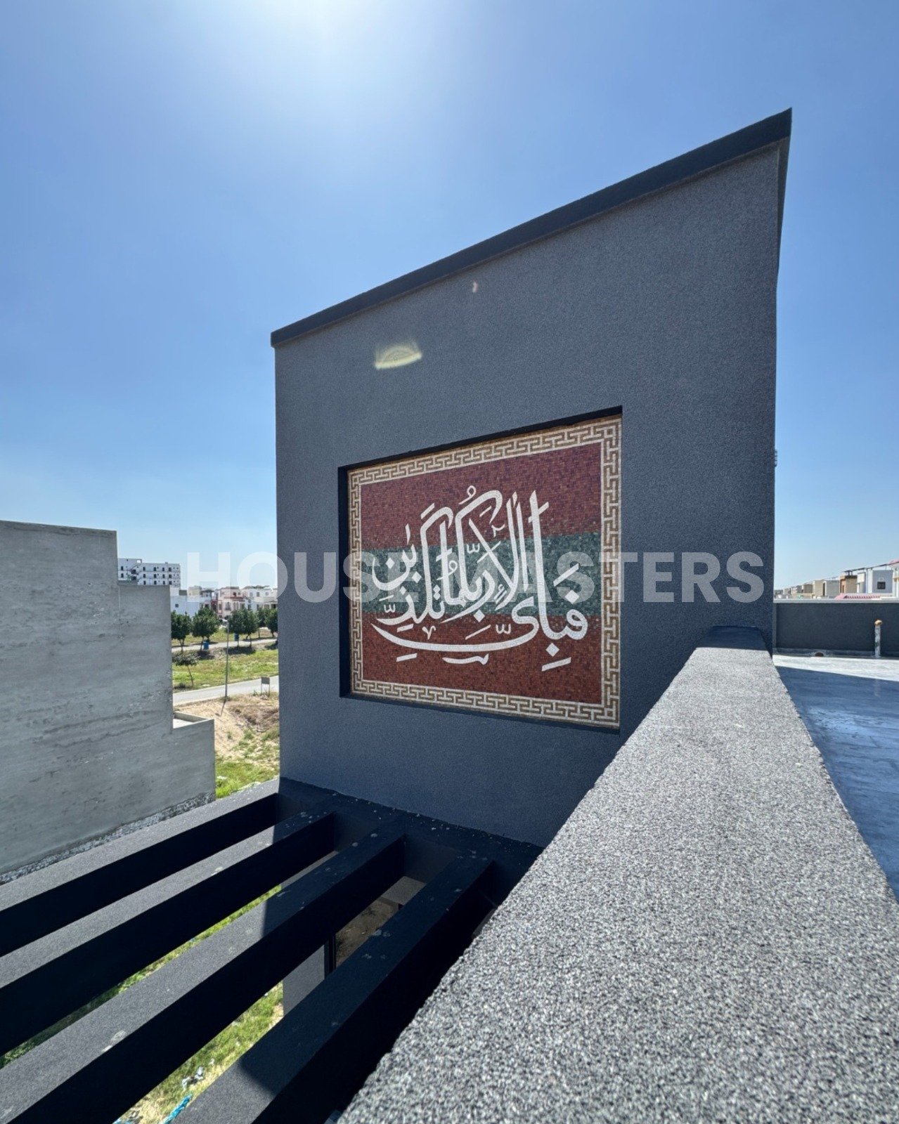 Rooftop area with black beams, modern wall lighting, and scenic view in 5 Marla luxury house, Bahria Orchard.