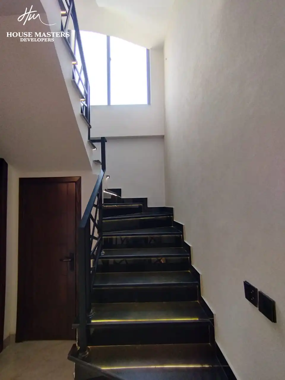 5 Marla Modern House for Sale in DHA Rahber Lahore Black marble staircase design with tread lighting in 5 Marla house
