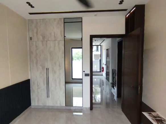 Luxury bedroom interior design with wooden flooring in DHA Rahber house