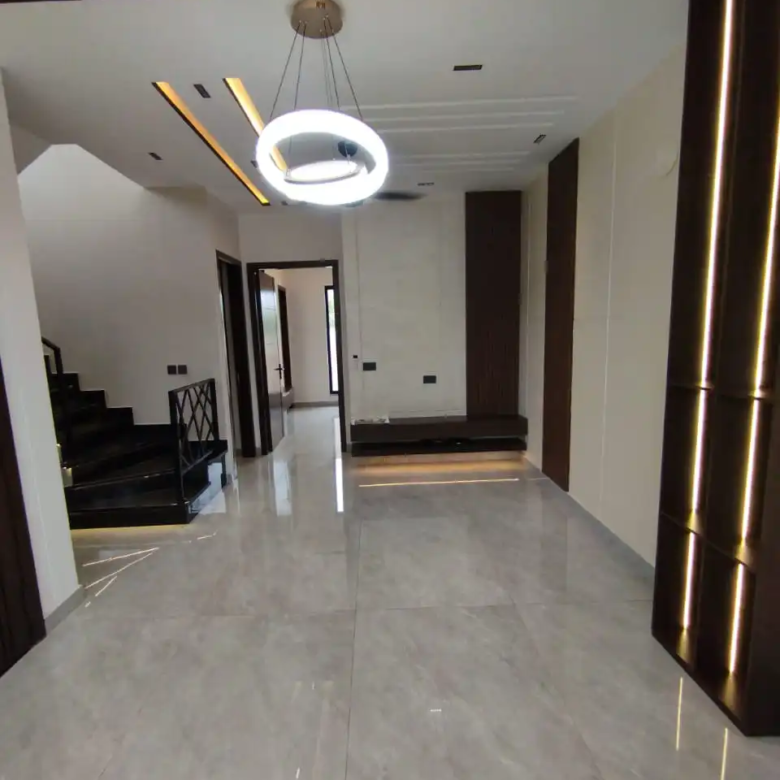 Spacious upper floor TV lounge room with dark wood panel accents