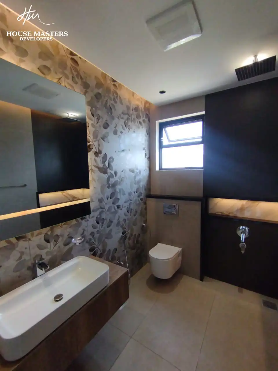 5 Marla Modern House for Sale in DHA Rahber Lahore Luxury bathroom with backlit LED round mirror and floral wall tiles