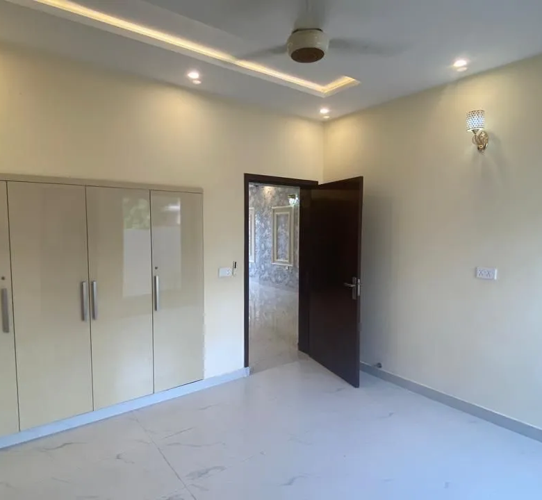 Spacious bedroom with luxury wardrobe and attached bathroom inside 5 Marla house for sale in Lake City Lahore.