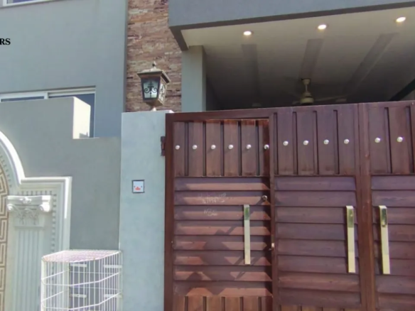 Main gate and modern exterior front of 5 Marla house for sale in Lake City Lahore M8.