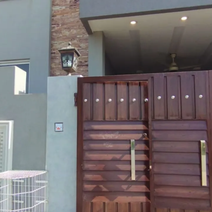 Main gate and modern exterior front of 5 Marla house for sale in Lake City Lahore M8.