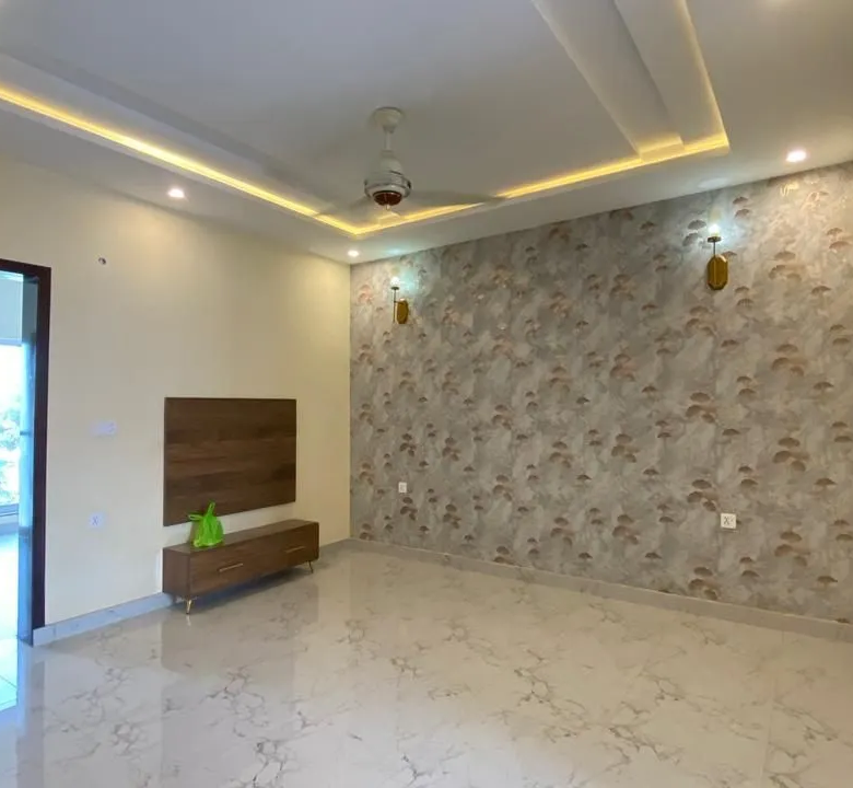 Elegantly designed TV lounge and drawing room area featuring modern ceiling lights and marble floors.