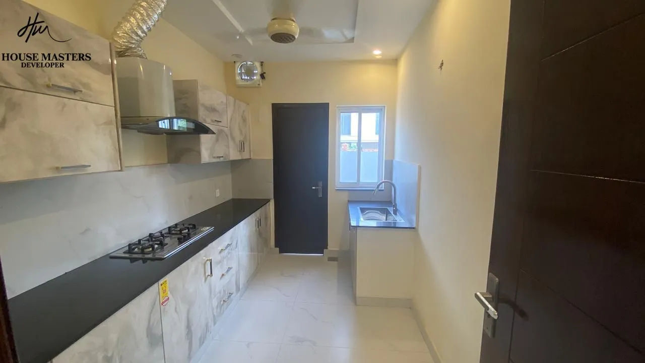 luxury bathroom interior 5 marla house Modern bathroom with premium marble tiles, floating vanity, and round mirror in Lake City Lahore M8 house.
